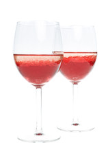 twoglass with colored red liquid on a white background