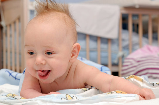Happy baby crawling in bed