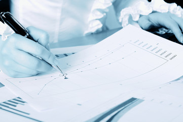 hand of a young business woman working with documents