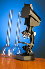 Microscope against blue gradient background
