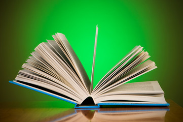 Stack of books against gradient background