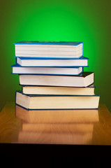 Stack of books against gradient background