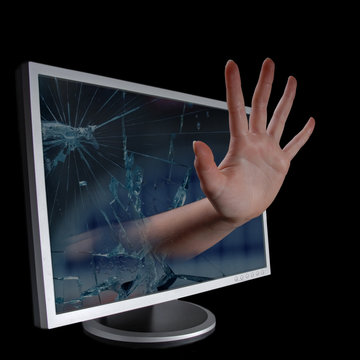 Hand stretching out through monitor