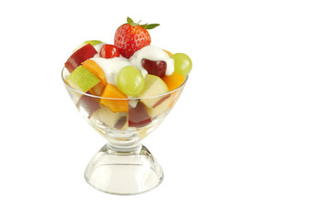 Bowl containing healthy fresh fruits with yogurt on the top