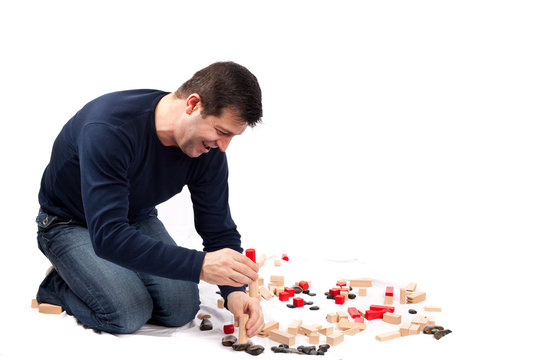 Man playing with wooden construction set