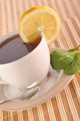 full cup of tea with lemon