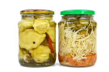 Glass jars with marinated cymblings and vegetable assortment