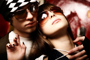 Fashionable young couple wearing sunglasses