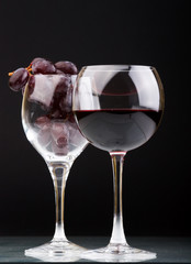 a glasses of red wine and grape.