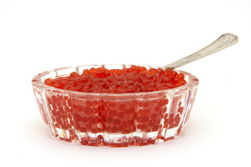 Dish full of red caviar with silver spoon