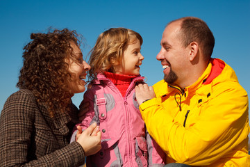 Portrait of happy family against blue sky