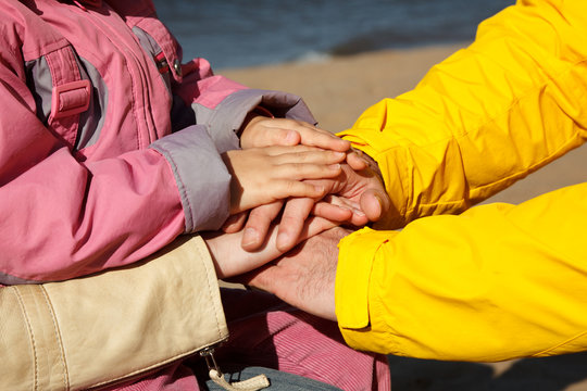 The connected hands of family as support and unity sign