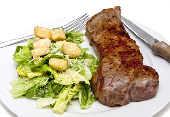 Steak and Caesar Salad on White Plate