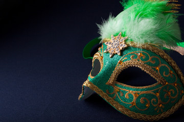 green and gold mask on dark  background