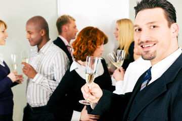 Drinking Champagne and celebrating in office