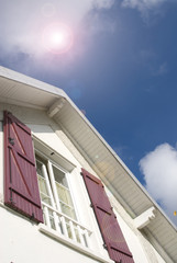 house on blue sky and sun
