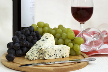 Still life with red wine, cheese and grapes