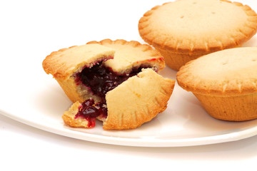 Tasty buns with berries on a white plate