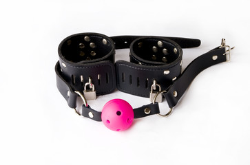 Gag and leather handcuffs.