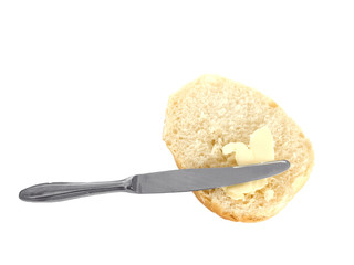 roll with butter and knife on white