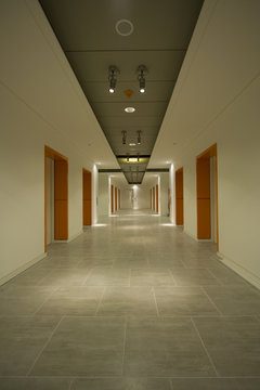 Long white corridor with orange doors