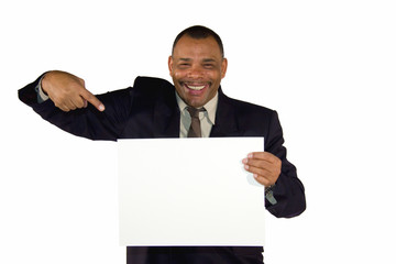 smiling African-American businessman pointing at white board