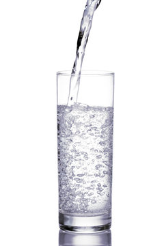Mineral water being poured into a glass.