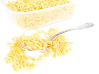 Short-cut pasta in plastic container with spoon.