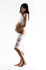 Young pregnant woman wrapped in white cloth