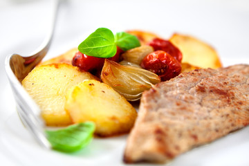 Roast pork with baked vegetables and basil
