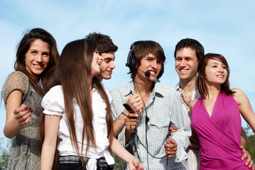 Group of young guys and girls having fun on the nature