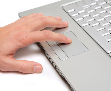 hand working on a laptop touchpad