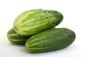 Ripe cucumbers on a white background