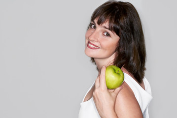 Portrait of young beauty woman with green apple