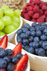 Bowls of Healthy Blueberries Raspberries Strawberries & Grapes