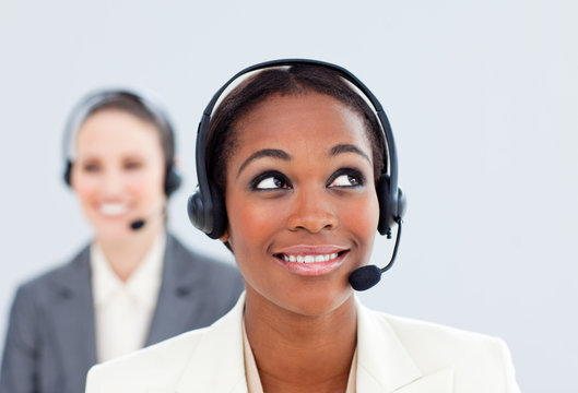 Charismatic businesswoman and her colleague with headset on