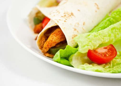 Mexican chicken fajita wraps with peppers and salad