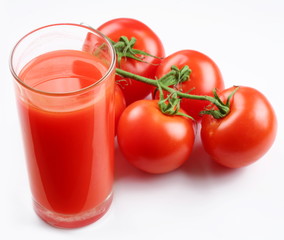 Glass of tomato juice and ripe tomatoes