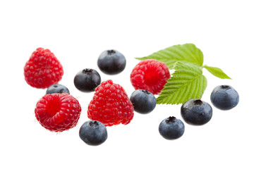 Raspberries and blueberries isolated on white