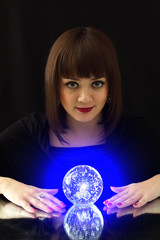 Girl and a magic ball on a black background