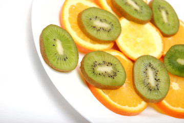 circle slices of kiwi and orange isolated