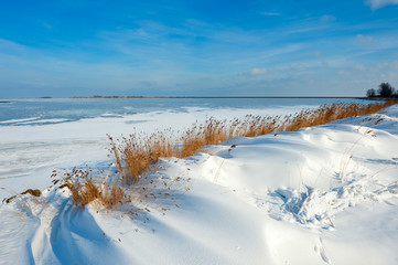 snow dunes at a lake in Winter