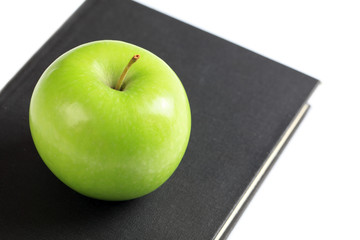 green apple on book