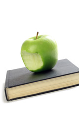 bitten apple on book