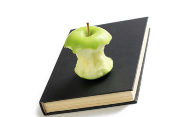 bitten apple on book