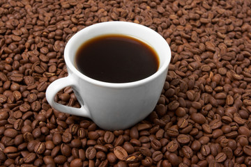 Cup with coffee, costing on coffee grain