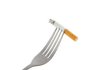 cigarette with ashes on  fork  isolated on white