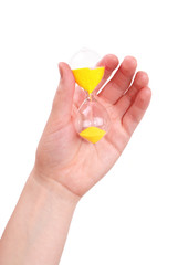 The female hand holds a sand-glass