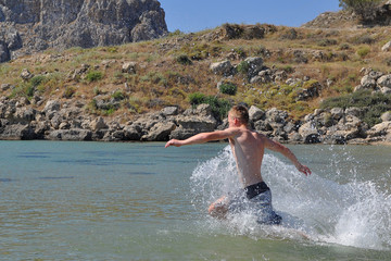 A boy rush in to the sea