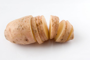 Raw sliced potatoes over white background